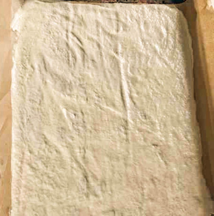 Sourdough discard crackers spread on sheet pan